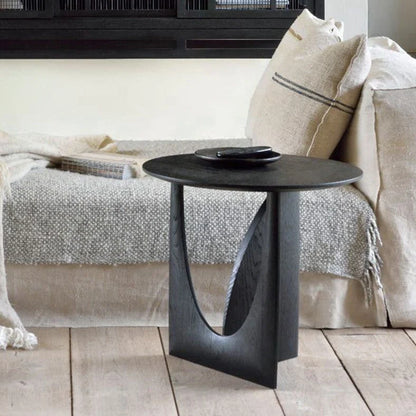 Round solid wood bedside table with geometric legs in walnut finish measuring 50cm diameter