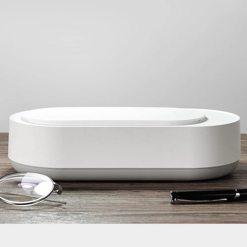 White portable ultrasonic cleaner with stainless steel tank for cleaning jewellery and glasses.