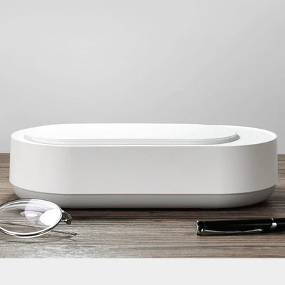 White portable ultrasonic cleaner with stainless steel tank for cleaning jewellery and glasses.