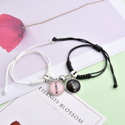 A pair of magnet couple bracelets with a suction clasp, showing various design options like clovers, crowns, and hearts.