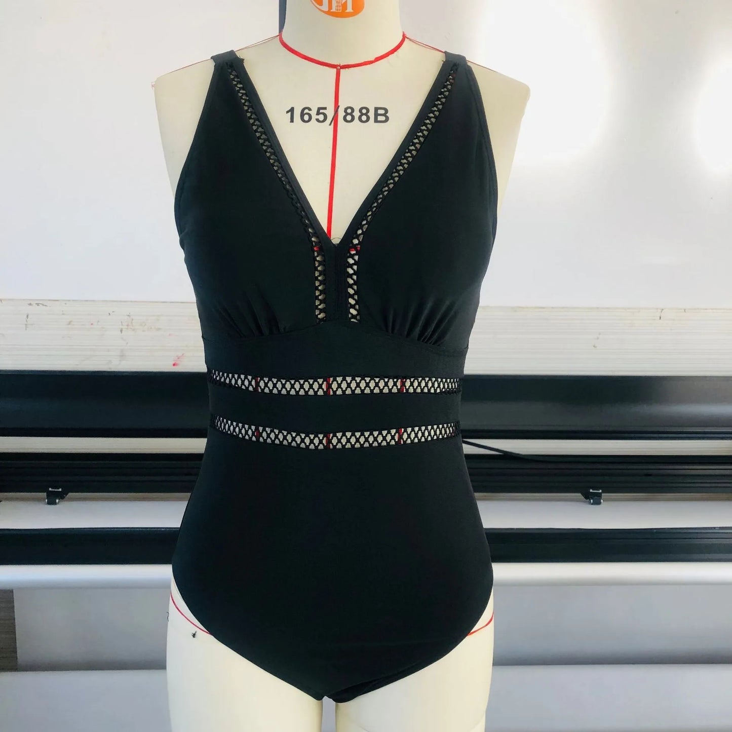 Black plus size bikini swimsuit with print design for women, shown on a hanger.
