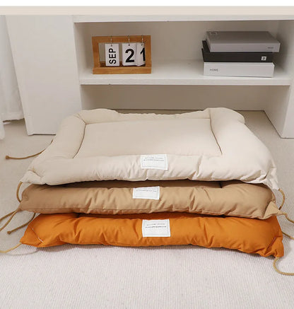 Beige cage cushion for dogs tied inside a metal crate, shown next to coffee and orange colour options.