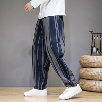 Navy blue and black striped men's casual trousers with a non-elastic waistband laid flat.