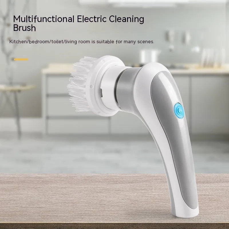White cordless electric spin scrubber with multiple brush heads on a bathroom tile.