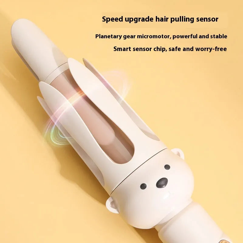 Beige automatic hair curler machine with negative ion technology and included styling stick on a table.