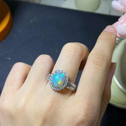 Handmade adjustable silver ring with a natural opal, shown in rose gold, yellow gold, and white gold plated finishes.