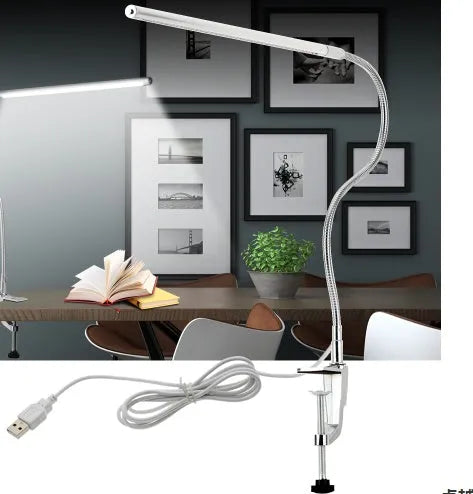Silver aluminium alloy USB-powered LED nail table lamp with a long arm clip attached to a table edge.