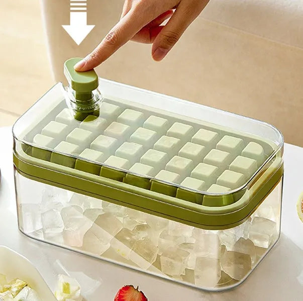 Green one-button press ice mould box with storage lid and ice shovel on kitchen counter