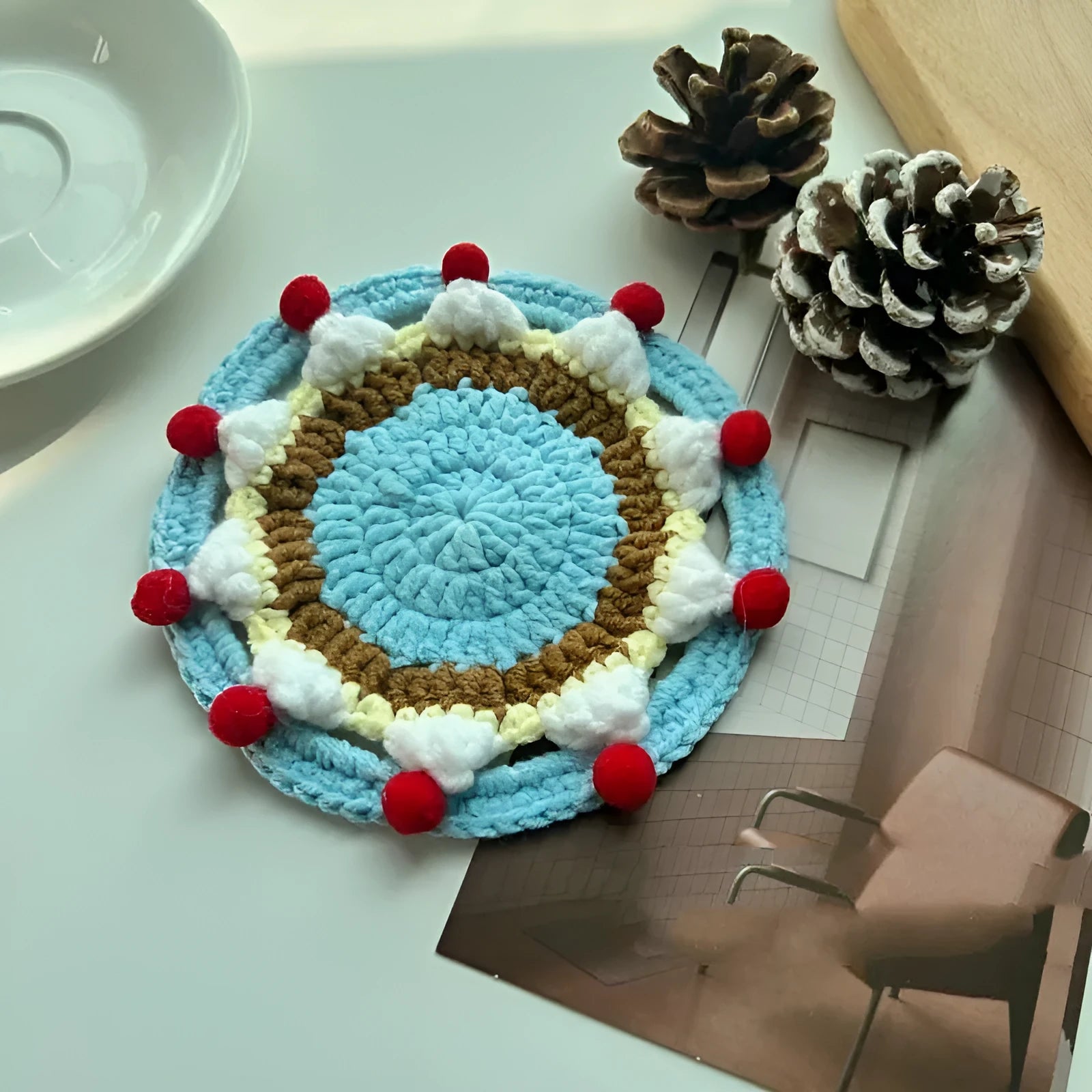 Finished wool crochet coaster bag with cake design measuring 9cm diameter