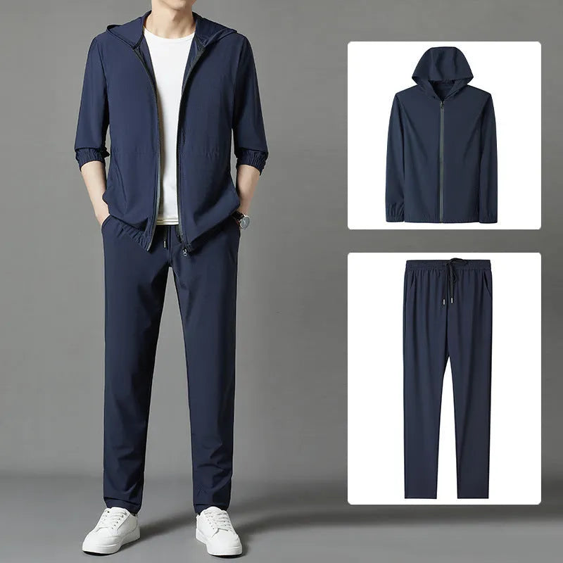 Grey hooded sun-protective top and loose pants suit for men on a hanger.