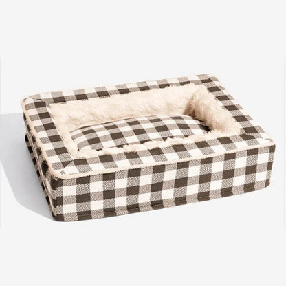 Classic red plaid dog bed cushion with a removable cover, shown in a large size next to a dog crate.