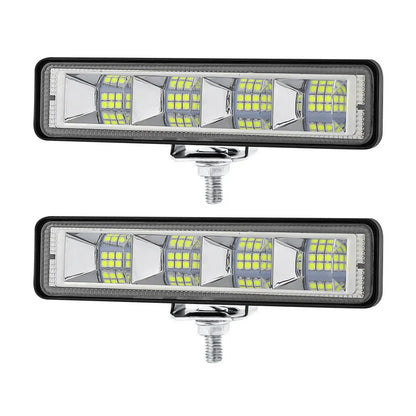 Four compact aluminium LED work lights in work light white colour, suitable for vehicle mounting.