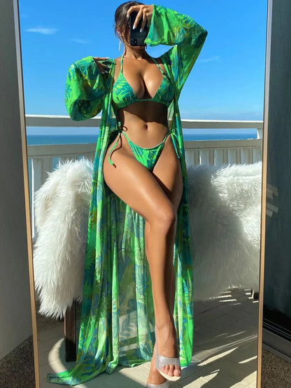 Polyester banded bikini set with long sleeve blouse, briefs, and robe cover-up in floral pattern