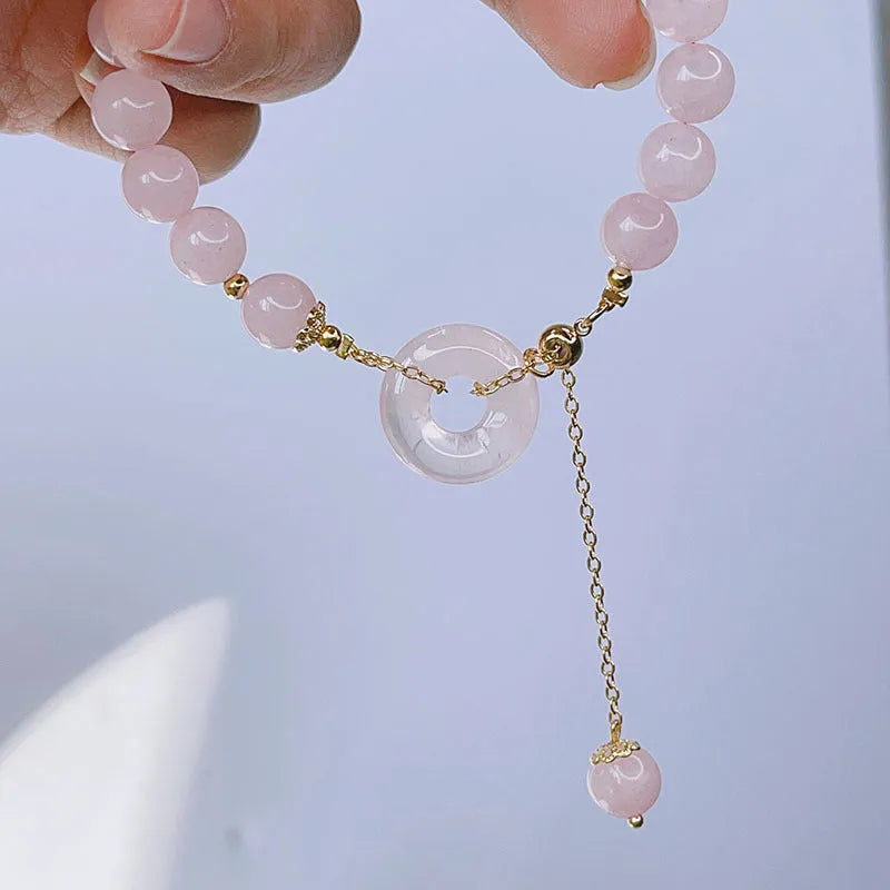 Pink crystal women's bracelet with peace buckle closure on adjustable band