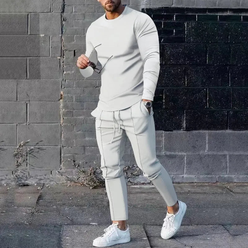 Men's solid colour two-piece lounge suit with long sleeve T-shirt and trousers in light grey.