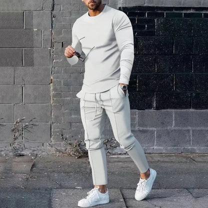 Men's solid colour two-piece lounge suit with long sleeve T-shirt and trousers in light grey.