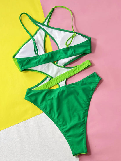 Green women's one-piece swimsuit with hollow contrast detail, made from nylon fabric.