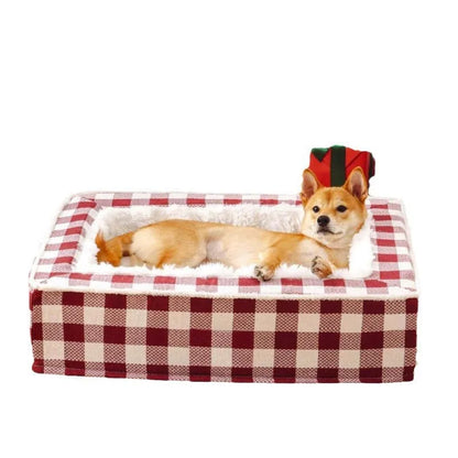 Classic red plaid dog bed cushion with a removable cover, shown in a large size next to a dog crate.