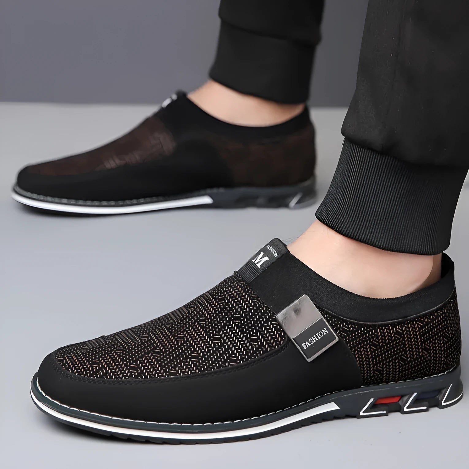 Men's grey and white synthetic leather slip-on casual shoes with a square toe and flat rubber sole.
