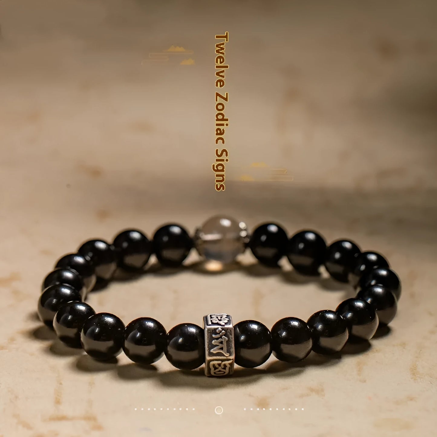 Obsidian bead bracelet with zodiac animal and Buddhist bodhisattva inlay designs.