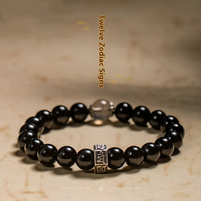 Obsidian bead bracelet with zodiac animal and Buddhist bodhisattva inlay designs.