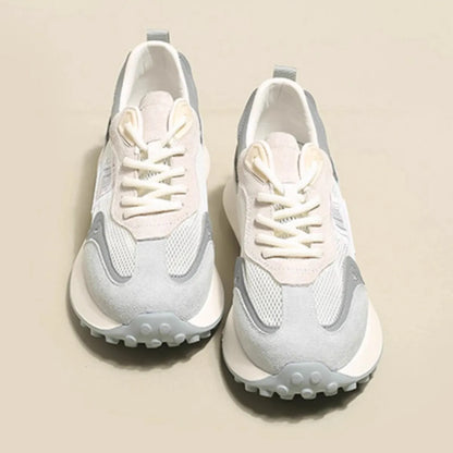 Women's grey low-top retro sneakers with mesh lining and round toe on a flat rubber sole.