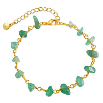Geometric women's bracelet with irregular turquoise stones in 18K copper on a white background.