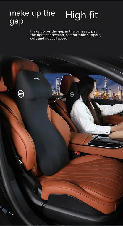 Black memory foam automotive waist cushion and matching headrest pillow set on a car seat.