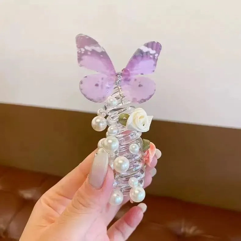 Colourful butterfly and pearl elastic hair band for children on a white background.