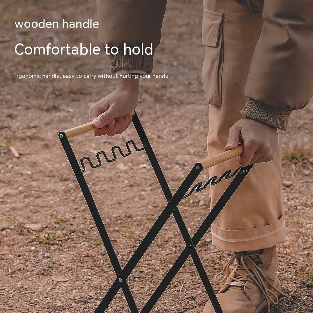 Black outdoor folding trash rack with wooden handle, holding a waste bag.
