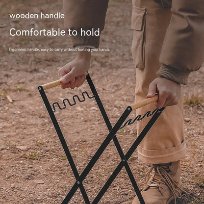 Black outdoor folding trash rack with wooden handle, holding a waste bag.