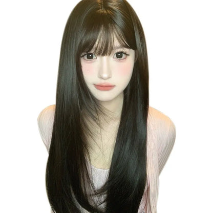 Dark brown long straight synthetic wig with fringe on a wig stand.