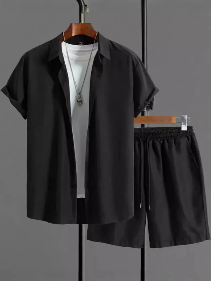 Man wearing a black and white jacquard short sleeve shirt and matching shorts suit set.