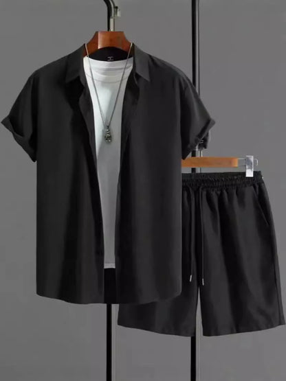 Man wearing a black and white jacquard short sleeve shirt and matching shorts suit set.