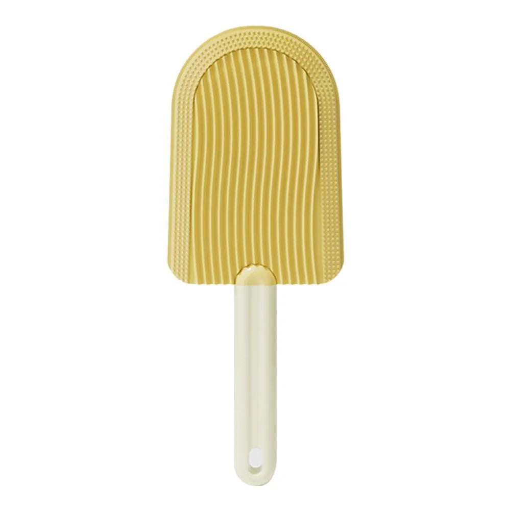 Foldable blue pet grooming brush with silicone teeth on a white background