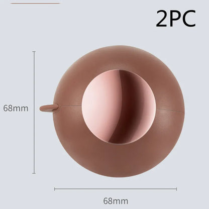 Reusable gel lint roller ball in green gold colour for removing pet hair and lint from fabrics.