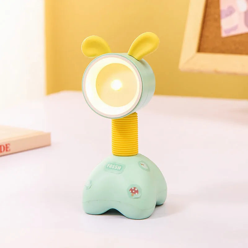 Colourful cartoon character magnetic DIY night light on a desk with adjustable head.