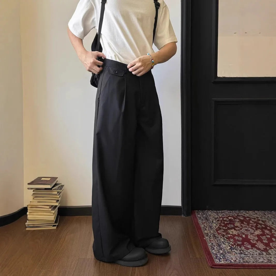Man wearing straight-leg wide-leg casual trousers in brown, showcasing the relaxed drape and fit.