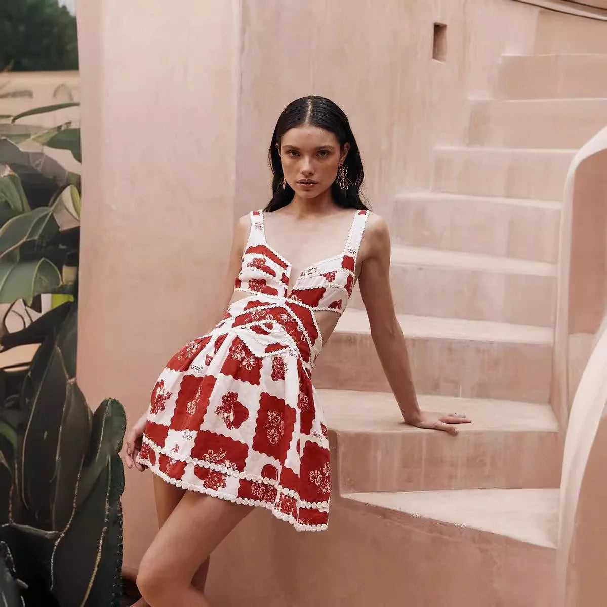 A beautiful red flower-patterned lace slip dress with a v-neck and waist cutout, perfect for summer fashion