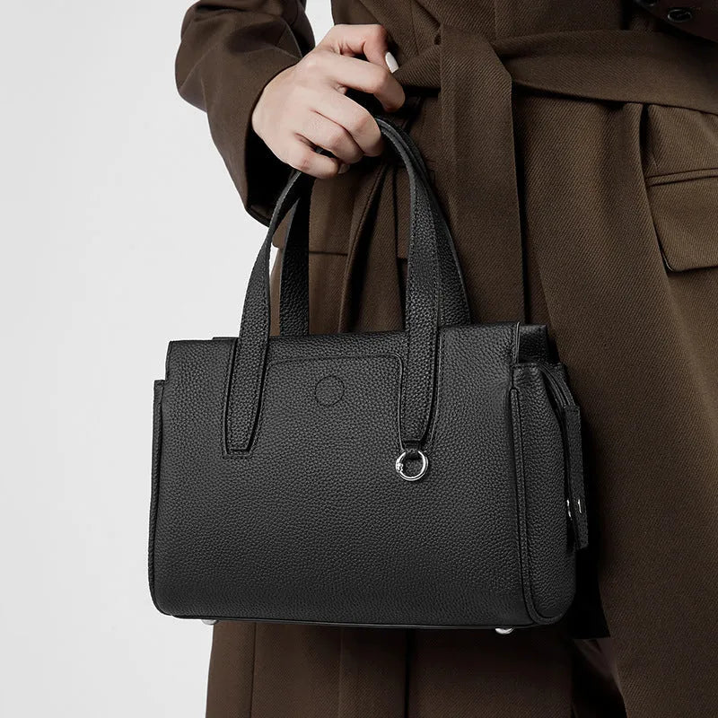 Genuine cowhide leather crossbody bag in a horizontal square shape with a single strap.