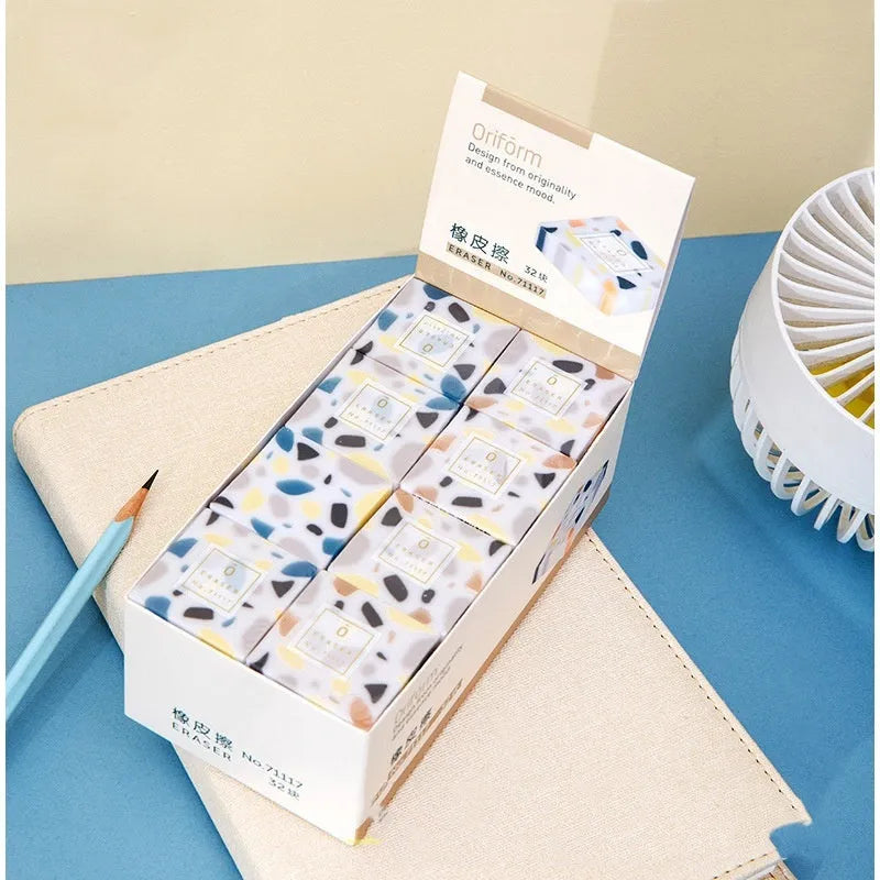 White rectangular rubber brick eraser for students on a blue background.