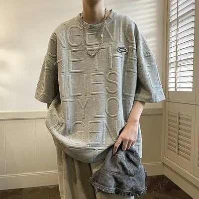 Grey men's short sleeve T-shirt with a raised retro letter design on the front.