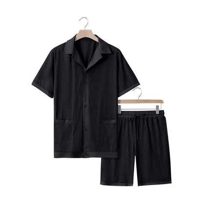 Light blue see-through beach shorts suit with matching cardigan on a summer background.