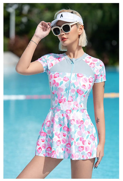 Printed plus size one-piece swimsuit on hanger, showing colourful pattern.