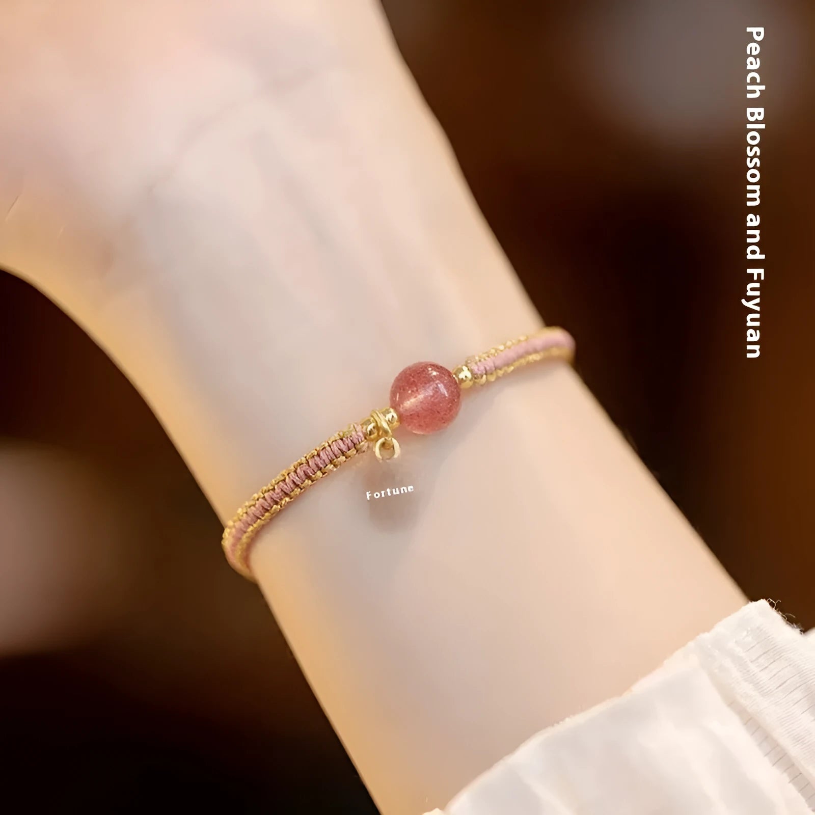 Adjustable red rope bracelet with transfer beads in Strawberry Quartz style on a wrist.
