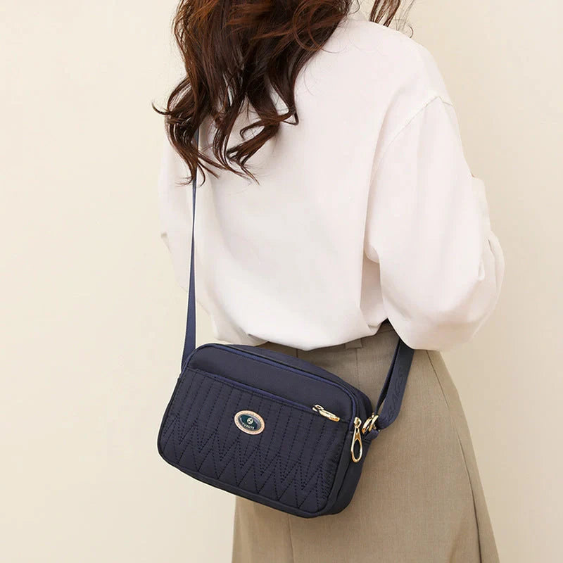 Compact nylon messenger bag for women in various colours with adjustable strap