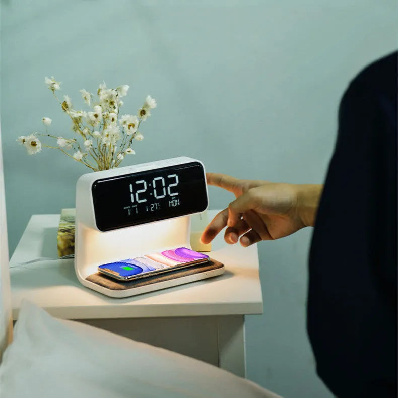 White 3-in-1 bedside lamp with wireless charging pad, LCD alarm clock screen, and touch controls.