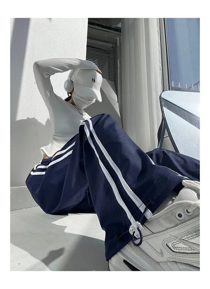Women's navy blue straight-leg trousers with white contrast ribbon parallel bars pattern design