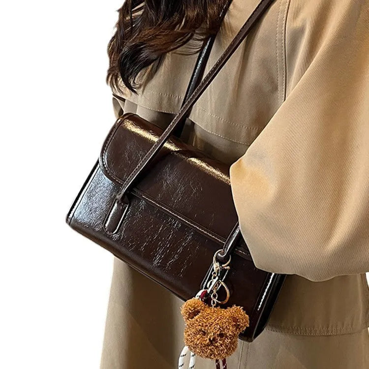 Brown women's square shoulder bag with double straps and pendant accessory