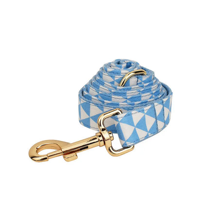 Blue cloth dog accessory set with collar, leash, bow, and vest shown together